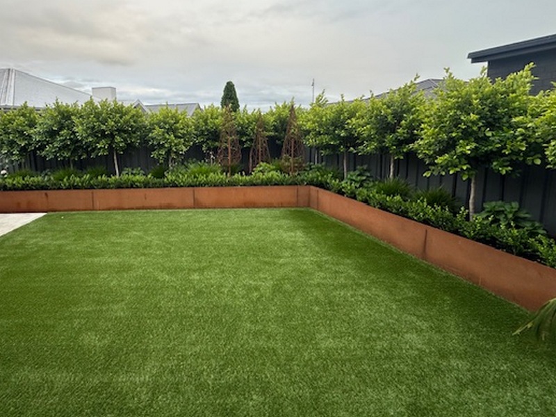 Corten steel raised garden bed planted with vegetables