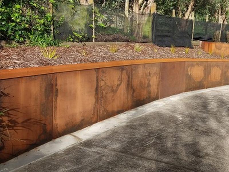 Clean architectural lines of metal retaining walls in a minimalist landscape.