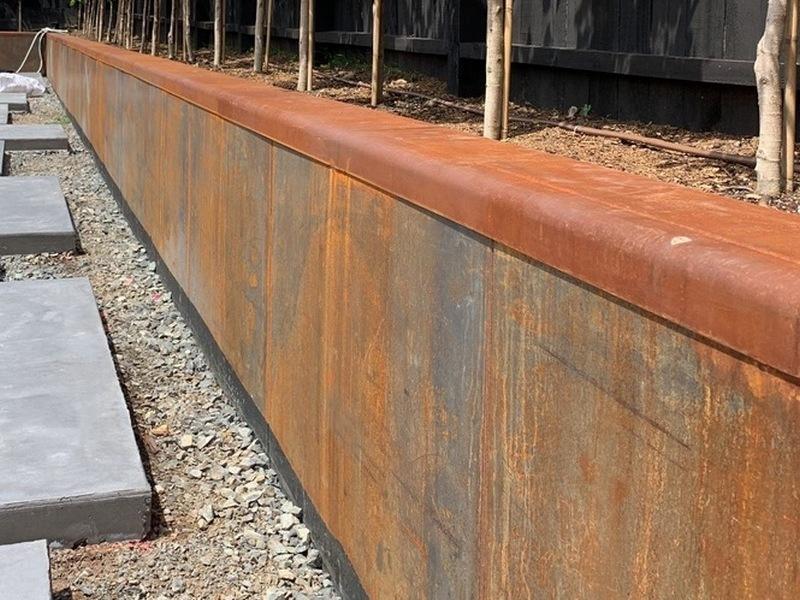 Texture detail of rusted metal retaining walls highlighting orange and brown hues.