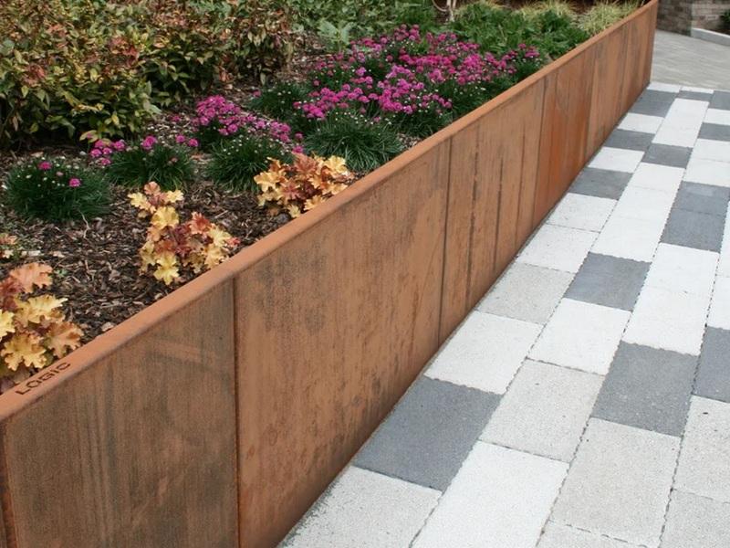 Step-by-step corten retaining wall installation in a residential backyard.